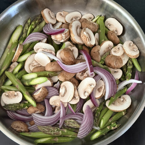 Asparagus, Mushrooms, and Red Onions in stainless steel pan